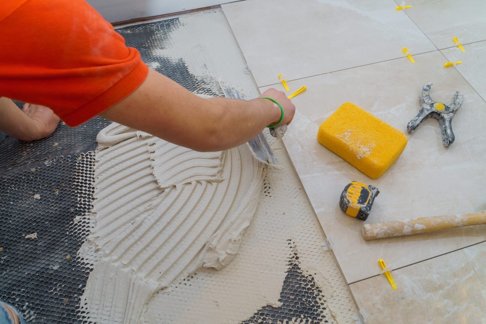 Applying new tiles on bathroom floor tile installation for house building