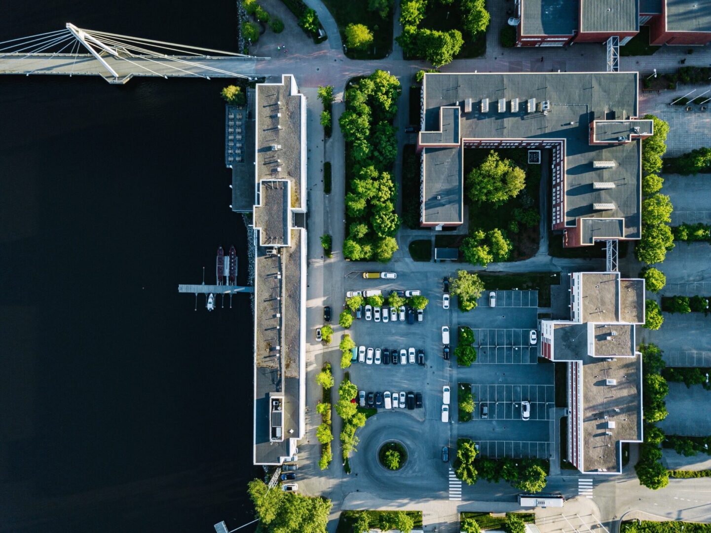 Aerial view of city buildings with car parking and lakeside. University of Jyvaskyla in Finland