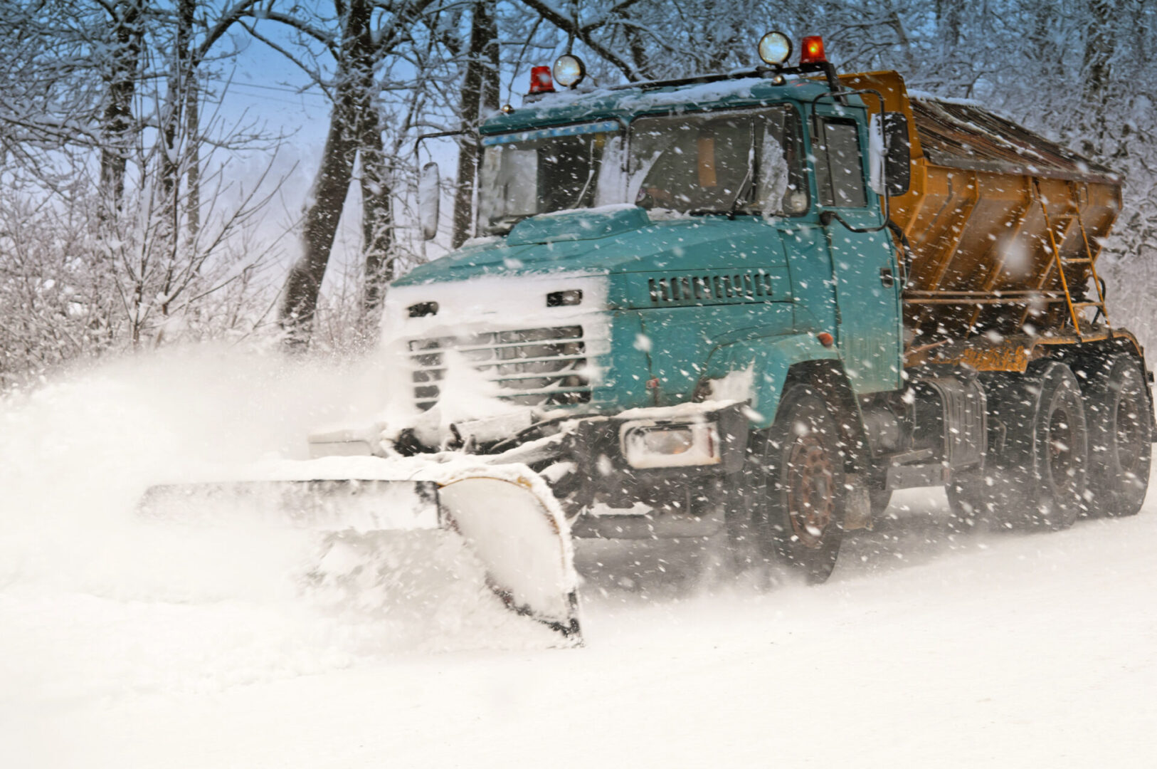 snow plow doing snow removal during blizzard